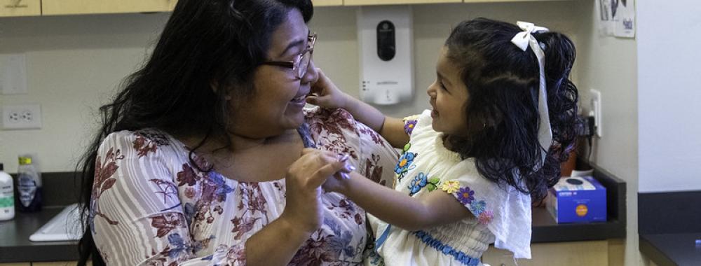 Photo of woman holding child